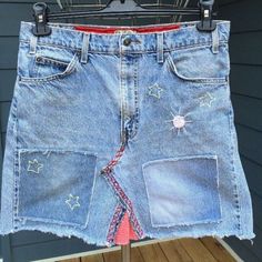 a skirt made out of jeans hanging on a clothes rack