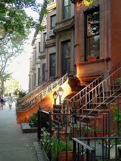 an apartment building with stairs leading up to it