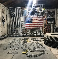 an old garage filled with lots of chains and other things in front of the american flag