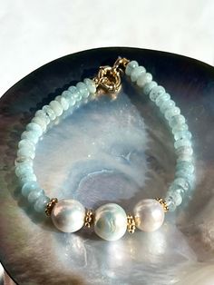 Elegant aquamarine bracelet made of freshwater pearls and natural aquamarine from Brazil. All metal parts gold vermeil (18k gold over sterling silver).  Bracelet length is 19 cm or 7,5 inches (please contact me if you need adjustments).  Beautiful gift for any occasion, especially for those who are born in March as aquamarine is the birthstone for this month.  Comes in a gift box. Shipment worldwide with registered post.  SPECIAL OFFERS: ✦ Special 10% OFF when you order 2 items!! Apply Coupon Co Aquamarine Bracelet Beads, Sea Jewelry, Aquamarine Bracelet, Edison Pearls, Aquamarine Jewelry, Bracelet Gemstone, Beaded Bracelets Diy, Natural Aquamarine, Bead Jewellery