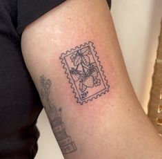 a woman's arm with a stamp on it that has flowers and leaves in it