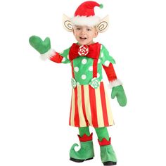 a young boy dressed in an elf costume and holding his hand out to the side