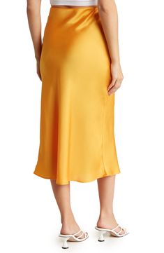 Elevate your wardrobe with this pull-on bias satin midi skirt for elegant, feminine style. 31" length (size S) Elasticized waist Pull-on style Satin construction 97% polyester, 3% spandex Machine wash cold, line dry Made in USA Model’s stats for sizing: 5’10” height, 34” bust, 27” waist, 35” hips. Model is wearing size S. Yellow Satin Skirt, Elegant Feminine Style, Yellow Satin, Elegant Feminine, Satin Midi Skirt, Skirts Online, Satin Skirt, Feminine Style, Midi Skirt