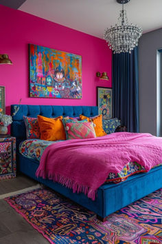 a bedroom decorated in bright colors with pink walls and blue bedding, chandelier and rugs