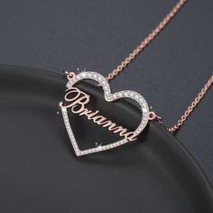 Surrounded Heart Name Necklace is the iconic symbol of love and affection. It symbolizes your love by making a barrier of affection surrounding the name of your choice. Cherish the one you love the most. Let his / her name sparkle near your heart. The pendant designed by our well-experienced jewelry designers based on the universal codes of love. It is not an illusion. The code of love is hidden deep and remains untold in our hearts.... Your pulse is the rhythm of her breath.... Touch your heart Custom Name Heart Necklace For Valentine's Anniversary, Custom Name Heart Pendant Jewelry For Valentine's Day, Personalized Heart Name Necklace, Personalized Heart-shaped Name Necklace, Valentine's Day Custom Name Heart Pendant Jewelry, Heart Cut Name Necklace For Valentine's Day, Round Name Necklace For Valentine's Day Anniversary, Customized Heart-shaped Rose Gold Necklaces, Rose Gold Name Engraved Heart Pendant Jewelry