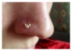 a woman's nose with a gold nose ring