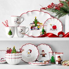 a shelf with christmas themed dishes and cups on it, decorated for the holiday season