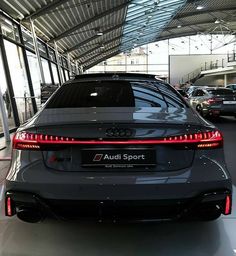 an audi sport car is parked in a showroom