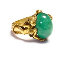 Antique Gold Large Cabochon Emerald Nude Lady Ring Dive into the enchanting realm of Art Nouveau with this magnificent gold ring, a testament to exquisite craftsmanship and artistic vision. This piece features a delicate assembly of sculpted ladies, each figure intertwined gracefully, representing the period's fascination with fluid, natural forms. At the center of this collective beauty sits a striking cabochon emerald, its lush green depths echoing the vibrant life of untouched nature. This si Gold Emerald Ring With Nature-inspired Design, Nature-inspired Gold Emerald Ring Gift, Gold Nature-inspired Emerald Ring As A Gift, Nature-inspired Gold Emerald Ring As Gift, Nature-inspired Gold Emerald Ring As A Gift, Nature-inspired Gold Emerald Ring For Gift, Art Nouveau Yellow Gold Intaglio Jewelry, Art Nouveau Gold Ring With Gemstone, Art Nouveau Yellow Gold Ring