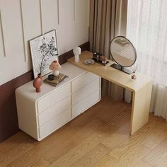 a desk with a mirror, vase and other items on it in front of a window