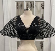 This Beautiful and Elegant Gwen Mettalic finish Blouse is designed exclusively by Siyaras Fashion House. We are sure this Ballon style mettalic blouse will turn heads during any event and once can nicely pair with matching or contrast satin/sequin skirt. The Blouse holds the ballon shape which falls nicely on the side.Fits size: size 36 plus has 4 inches margin. Material: Satin with Net and Metallic finish to give the Ballon Shaped Look. Black Satin Party Blouse, Glamorous Padded Blouse For Evening, Satin V-neck Party Blouse, Glamorous Party Blouse Piece With Sequins, Black Satin Tops For Party, Party Satin Unstitched Blouse Piece, Festive Satin Blouse Piece For Party, Festive Satin Party Blouse Piece, Party Satin Blouse With Padded Detail