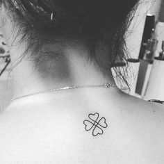 a woman with a clover tattoo on her back