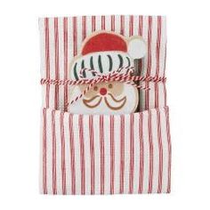 a red and white striped gift bag with a santa face cookie in the pocket on top