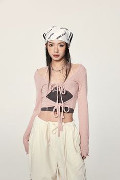 Elevate your style with our Long Sleeve Crop Top with Lace-Up Detail, a perfect blend of edgy allure and sophisticated craftsmanship. Made from a soft knit fabric, this crop top features a unique lace-up design that adds a hint of intrigue to your outfit. The V-neckline and long sleeves create a balanced silhouette, while the solid color and delicate details enhance its versatility. Whether it's for a casual outing or a special evening event, this top is sure to make a statement. Pair it with hi Edgy Fitted Crop Top For Spring, Edgy Winter Crop Top, Y2k Fitted Crop Top For Winter, Chic Bandage Crop Top, Edgy Cropped Crop Top For Spring, Chic Cropped Bandage Tops, Trendy Fitted Bandage Crop Top, Chic Cropped Bandage Crop Top, Chic Bandage Crop Top For Spring