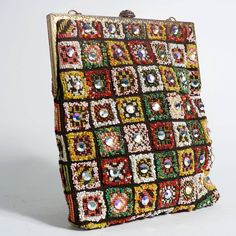 Description: Vintage 1960's beaded and jeweled carpet bag Made up of vibrant jewels and seed beads Gold chain Gold brocade style closure along with gold frame Width: 9" Length: 10" 8" chain Details: Size: OSColor: MulticoloredCondition: Good Shipping: Standard: $9.95Expedited: $19.95 Vintage Handwork Evening Bag For Party, Vintage Embellished Rectangular Bag, Multicolor Sequined Evening Bag, Hand Embellished Multicolor Evening Bags, Vintage Bags For Festivals, Evening Multicolor Hand Embellished Bags, Antique Beaded Rectangular Evening Bag, Vintage Rectangular Bags For Festive Occasions, Multicolor Sequined Rectangular Evening Bag