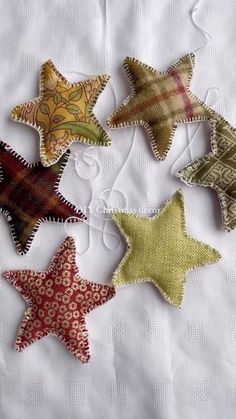 five star shaped fabric ornaments on a white table cloth