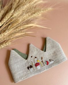 Handcrafted Linen Birthday Crown Celebrate your child's special day with this beautiful, handmade crown. Crafted from premium linen, it features delicate hand-embroidered floral patterns, making it a unique keepsake. The adjustable tie ensures a comfortable fit for any age. 🌸DETAILS: ✔️Material: Linen & cotton with hand embroidery. ✔️Size: One size, adjustable tie closure. ✔️Handmade in Vietnam: Crafted by skilled traditional embroiderers. 🌸FEATURES: ✔️Eco-friendly, soft, and durable linen. ✔️ Whimsical Tall Crown As Gift, Handmade Pinched Crown As A Gift, Handmade Pinched Crown As Gift, Embroidery Party Hat, Adjustable Embroidered Party Hat, Birthday Crown Embroidery, First Birthday Embroidery, Sew Birthday Crown, Embroidered Birthday Crown