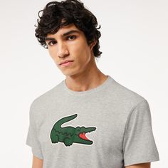 A T-shirt designed for intense exercise by Lacoste, sporting experts since 1933. Made from technical jersey, with cotton for comfort and Ultra Dry technology to wick away moisture. Plus an iconic, XL crocodile print for Lacoste signature style. Sporty Crew Neck T-shirt With Branding, Grey Logo Print Crew Neck T-shirt, Athletic Heather Crew Neck T-shirt With Logo, Athletic Heather T-shirt With Logo Crew Neck, Short Sleeve Logo T-shirt In Athleisure Style, Gray Sportswear T-shirt With Graphic Print, Athleisure Sports T-shirt With Logo, Athleisure T-shirt With Sports Logo, Sports Logo T-shirt In Athleisure Style