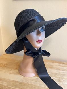 This black 4 inch down turn brim Toyo straw hat is very durable and keeps the shape, great for travel. The hat has a removable black satin  2 1/2 inch ribbon also available in white and cream on request. Another option is thin black or white raw edged Grosgrain ribbon for the under chin tie, please see photos. The hat will fit up to 22 5/8 inch head size with an inside sizing cord to adjust to your head size. You can easily remove the tie and use another ribbon to match your outfit. The raw edged ribbon is also available in rose pink.  NOTE: Please check the head size before purchase, I am happy to answer any questions you may have. There will be a 20% restocking fee for all returned hats. Satin Noir, Cool Hats, White Ribbon, Brim Hat, Sun Hat, Wide Brimmed, Straw Hat, Rose Pink, Grosgrain Ribbon