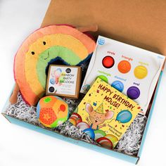 a birthday gift box with toys, books and cards for children to play in it