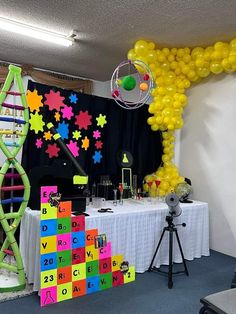 a room with balloons and decorations on the wall, including a ferris wheel in the center