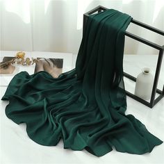 Our textured satin hijabs are fit for a queen like you! Made of silky satin with a subtle texture to prevent slipping, they're easy to style, lightweight, and have a beautiful shine. Perfect choice for evening wear and special occasions. Don't miss out on this luxurious must-have! Material: Satin Chiffon Size: 70*180 Elegant Silk Scarf For Eid, Elegant Green Hijab, Elegant Solid Color Chiffon Hijab, Elegant Solid Chiffon Hijab, Wrap Turban, Beach Scarf, Shawl Style, Headband Wrap, Luxury Scarves