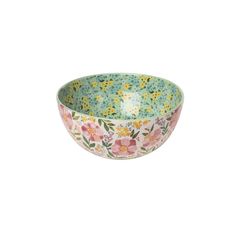 a bowl with flowers painted on the outside and inside, sitting in front of a white background