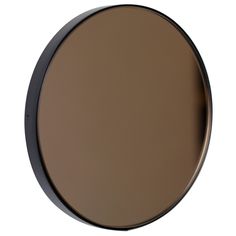 a round mirror on the wall is shown in black and brown colors, with a white background