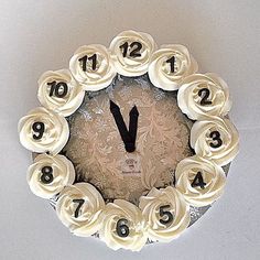 a clock made out of cupcakes with numbers on it