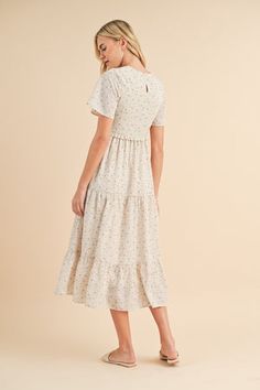 Floral smocked midi dress in ecru-NEW – JanieLanie Elegant Smocked Midi Dress With Ruffle Hem, Elegant Midi Smocked Dress With Ruffle Hem, Casual Midi Dress With Ruffle Hem, Beige Ruffle Hem Midi Dress For Day Out, Cream Short Sleeve Dress With Smocked Bodice, Ruffled Mid-length Maxi Dress For Day Out, Vacation Midi Dress With Smocked Bodice And Flutter Sleeve, Vacation Midi Dress With Ruffle Hem, Casual Midi Dress With Smocked Bodice And Flutter Sleeves