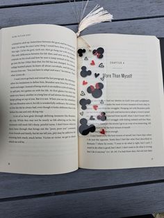 an open book sitting on top of a wooden table