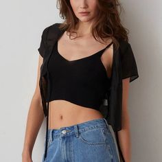 This Back Ribbed Knit Tank Is Perfectly Cropped To Fit Under Cardigans Or To Wear On Its Own. Pair With The Sheer Tie Overlay. Rib Knit Sleeveless V-Neckline Model Is Wearing Size Small 80% Viscose 20%Nylon Black Top With Built-in Bra For Day Out, Black Seamless Crop Top For Layering, Black Tops With Built-in Bra For Day Out, Yellow Crop Top, Wrap Crop Tops, Crop Tank Top, Crop Top Sweater, Short Sleeve Cropped Top, Knit Tank