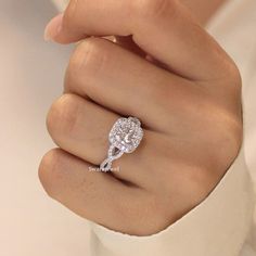 a woman's hand with a diamond ring on it