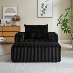 a black chair and ottoman in a room