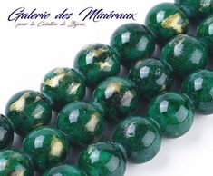 green beads with gold flecks are lined up