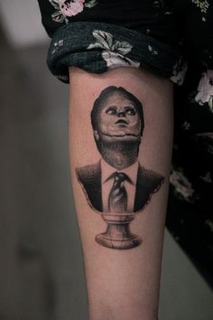 a woman's arm with a tattoo of a monkey wearing a suit and tie