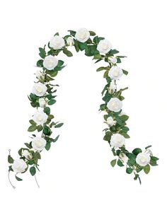 white roses and green leaves are arranged in the shape of an arch