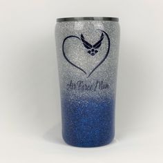 a blue and silver glittered cup with an eagle on the side that says, all you need is love