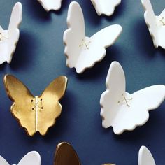 some white and gold butterflies on a blue surface