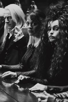 black and white photograph of three women sitting at a table