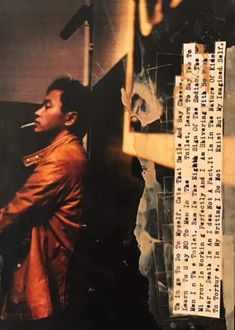 a man standing in front of a mirror with writing on the wall next to him