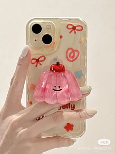 a person holding up a phone case with a pink flower on the front and bottom