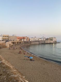 the beach is crowded with people and umbrellas