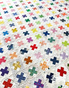 a multicolored quilt with crosses on it