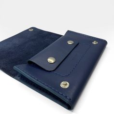 Trucker wallet is slim style with a card slot and coin purse with a metal silver buttons. Made of soft dark blue leather. * Composition: 100% leather * Dimensions: Width: 16 cm (6.3 inch) Height: 9.5 cm (3.7 inch) Depth: 1,2 cm (0.5 inch) Classic Blue Trifold Wallet For Everyday Use, Blue Leather Card Holder With Interior Slots, Classic Blue Trifold Wallet With Card Slots, Classic Blue Leather Wallets, Classic Blue Leather Wallet, Blue Leather Trifold Wallet With Card Slots, Leather Wallets With Snap Closure For Gift, Blue Trifold Wallet With Coin Pocket, Leather Wallet With Snap Closure As Gift