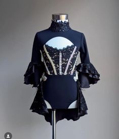 a mannequin wearing a black dress with sequins on it