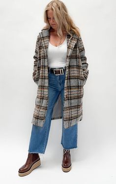 Introducing our classic Plaid Coat—the perfect blend of timeless style and modern practicality. Crafted with a chic plaid pattern, this coat features a long silhouette for extra warmth and elegance. Functional pockets keep your essentials close, while the button-up closure ensures a snug fit on chilly days. Whether you're running errands or heading out for a night on the town, this versatile coat effortlessly elevates any outfit. Ideal for the busy woman who wants to stay cozy without sacrificing style! Material: 95% Polyester / 5% Wool Chic Plaid Long Coat, Plaid Outerwear For Cold Weather In Fall, Classic Plaid Long Coat, Trendy Plaid Outerwear For Cold Weather, Chic Plaid Single Breasted Outerwear, Chic Plaid Single-breasted Outerwear, Plaid Long Coat With Pockets, Plaid Winter Outerwear For Work, Winter Plaid Outerwear For Work