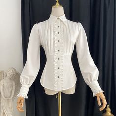 A blouse that looks like an aristocratic lady from medieval Europe. A gorgeous item decorated with frills and pleats on the chest. The cuffs are long and the waist is tapered. For a young lady with a noble atmosphere. 
 

 

 
 
 
 Color 
 
 White 
 pink 
 Gray 
 Navy 
 
 
 Size 
 
 
 S size 
 
 Length: 59cm 
 Shoulder width: 35-37cm 
 Bust: 86cm 
 Waist: 68cm 
 Sleeve length: 61cm 
 
 M size 
 
 Length: 60cm 
 Shoulder width: 36-38cm 
 Bust: 92cm 
 Waist: 74cm 
 Sleeve length: 61.5cm 
 
 L size Long Sleeve Victorian Dress With Historical Design, Feminine Victorian Dress With Ruffles And Long Sleeves, Feminine Long Sleeve Victorian Dress With Ruffles, Long Sleeve Feminine Victorian Dress With Ruffles, Fitted Blouse With Bishop Sleeves And Buttons, Fitted Bishop Sleeve Blouse With Buttons, Formal Fitted Blouse With Lantern Sleeves, Formal Fitted Lantern Sleeve Blouse, Victorian Dress With Ruffles And Puff Sleeves