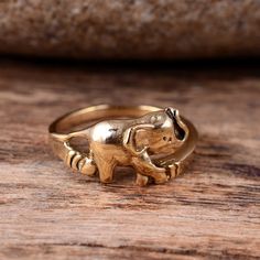 an elephant ring sitting on top of a wooden table