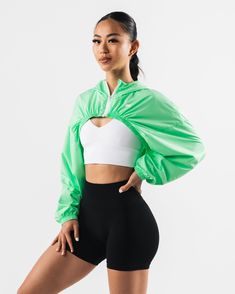 HIGHLIGHTS. Woven fabric Long sleeve Alphalete wolf logo FIT SUGGESTION. This item runs true to Alphalete's standard size... Jessica is 5’3”/160cm, wearing a size XS with a 30”/77.5cm bust. MATERIALS AND WASHING DIRECTIONS. 100% Polyester. We recommend washing inside-out on a cold setting. Hang to dry DESCRIPTION With a silky smooth woven fabric, this jacket is perfect for wearing to and from the gym or during a cold outdoor workout for some added warmth. The wide sleeves and gathered hem make f Spring Nylon Outerwear For Athletic Use, Green Stretch Athleisure Outerwear, Green Athleisure Outerwear For Workout, Spring Athleisure Running Windbreaker, Spring Functional Running Outerwear, Functional Green Stretch Outerwear, Functional Spring Running Outerwear, Spring Nylon Outerwear For Workouts, Green Sportswear Outerwear For Workout